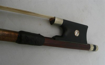 Lot 197 - A 19th century French nickel mounted cello bow, unmarked, the ebony frog inlaid with pearl...