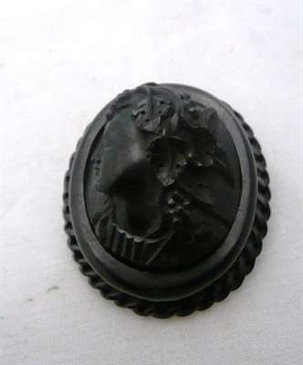 Lot 214 - A carved Whitby jet cameo brooch depicting a woman