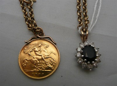 Lot 233 - A 1909 half sovereign with gold mount and chain also another pendant