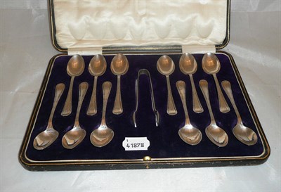 Lot 255 - A cased set of twelve silver teaspoons and a pair of sugar tongs, approx 7oz