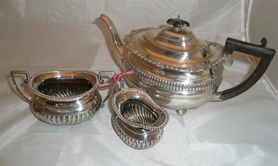 Lot 305 - A silver harlequin three piece tea service, 30oz