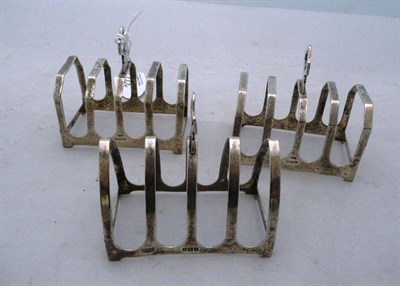 Lot 322 - Three silver toast racks