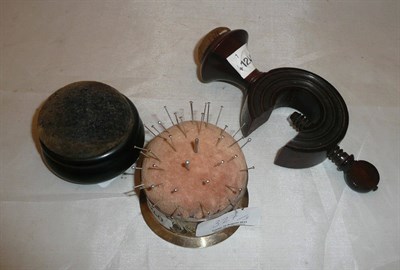 Lot 327 - A rosewood needlework clamp, a silver pin cushion and an ebony pin cushion