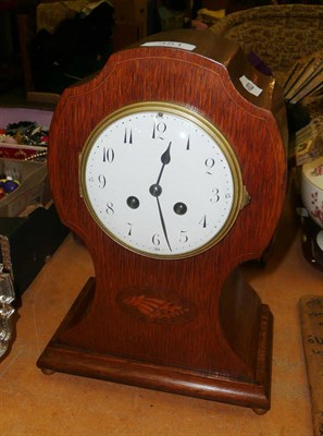 Lot 351 - An Edwardian golden oak mantel clock by Japy Freres with key and pendulum