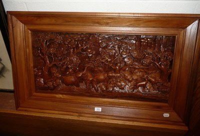 Lot 383 - A Thai teakwood carved large panel depicting a jungle scene, circa 2000