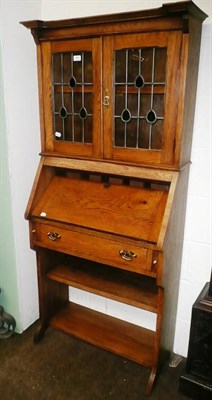 Lot 409 - An Arts & Crafts oak small bureau bookcase