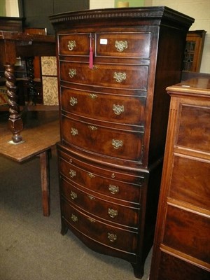 Lot 421 - A reproduction walnut bow-fronted tallboy with cabinet top and drawers below