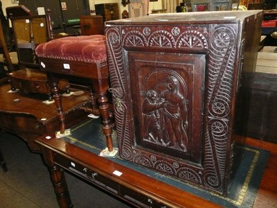 Lot 424 - Adjustable mahogany piano stool and a carved oak cupboard