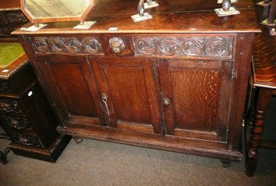 Lot 432 - A carved oak cupboard