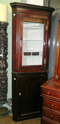 Lot 493 - A floor standing corner cabinet with glazed upper section