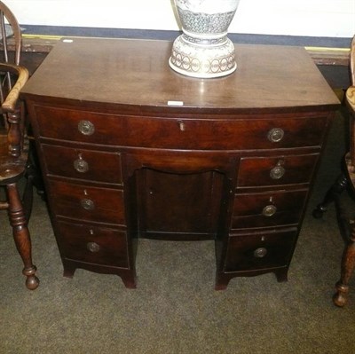 Lot 506 - George III mahogany bow front kneehole desk