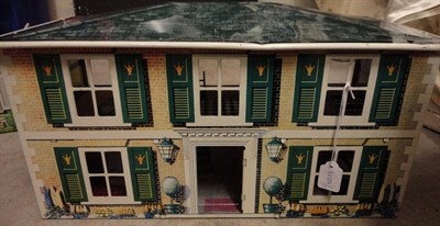 Lot 1012 - Circa 1950's Louis Marx Tin Plate And Lithograph Decorated Dolls House, with stone and yellow...