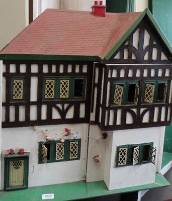 Lot 1029 - Circa 1930's Dolls House with painted tin windows, front opening double doors enclosing four...