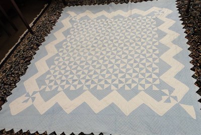 Lot 1059 - Pale Blue And White Geometric Patterned Quilt with zig zag edging, 190 cms by 220 cms