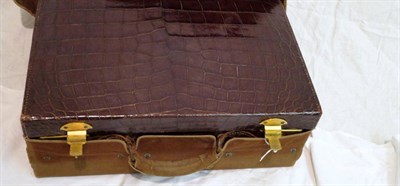 Lot 1121 - Brown Crocodile Leather Travelling Case with gilt metal locks, lined in a silk taffeta with a...