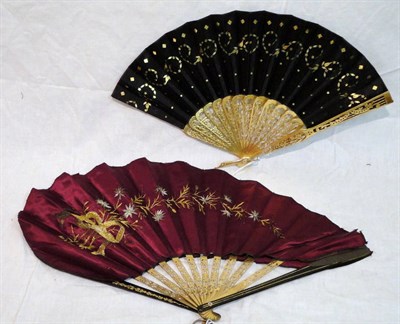 Lot 1153 - Late 19th Century Patent Fan With Brass Sticks And Ebonised Guards, with a red satin tear drop...