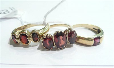 Lot 63 - 9ct gold garnet three stone ring, another and a 9ct gold garnet ring