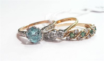 Lot 64 - A blue zircon ring, a 9ct gold emerald and diamond ring and a diamond three stone ring