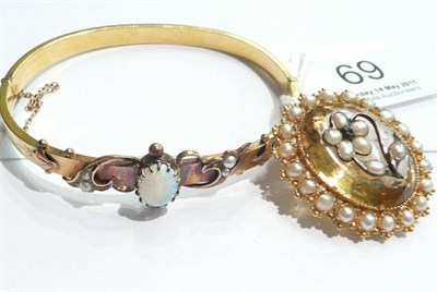 Lot 69 - An opal and half pearl bangle and a citrine and half pearl brooch