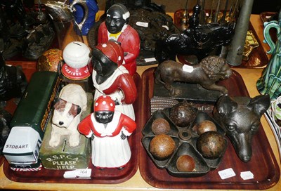 Lot 164 - Two trays of assorted cast metal door stops, money boxes, etc