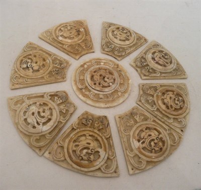 Lot 171 - A nine piece jade type roundel, Chinese 19th Century