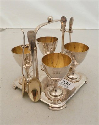 Lot 206 - A silver egg stand with four cups and spoons