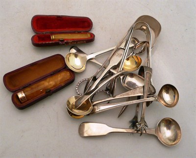 Lot 220 - A pair of silver sugar nips, four pairs of silver sugar tongs, five assorted spoons and two cheroot