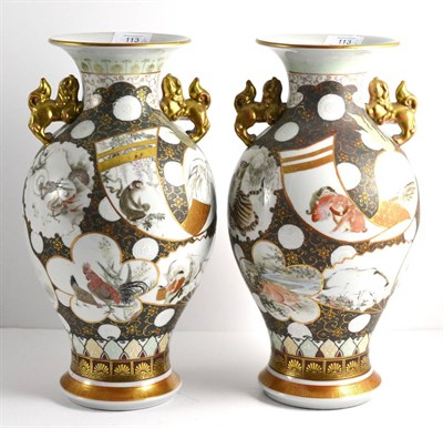 Lot 113 - A Pair of Kutani Porcelain Baluster Vases, circa 1900, with shi-shi handles, painted with...
