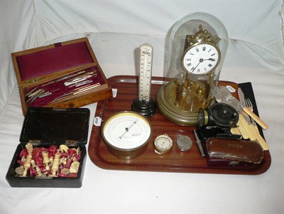 Lot 230 - A tray including a pocket barometer, aneroid barometer, cased drawing items, domed clock, chess...