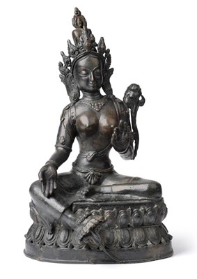 Lot 115 - A Nepalese Bronze Figure of Green Tara, 16th/17th century, the seated figure with pierced...