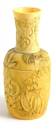 Lot 139 - A Japanese Ivory Bottle Vase, 19th century, carved with fruiting vine and flowering branches,...
