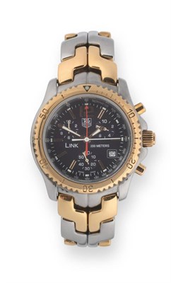 Lot 187 - A Steel and Gold Calendar Chronograph Wristwatch, signed Tag Heuer, model: Link, 200 Meters,...