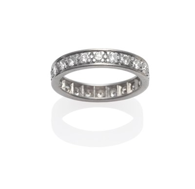 Lot 207 - A Diamond Eternity Ring, round brilliant cut diamonds in white claw settings with a flat sided...