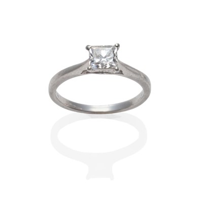 Lot 243 - A Platinum Diamond Solitaire Ring, the princess cut diamond in a claw setting on a tapered shoulder