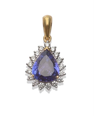 Lot 275 - A Tanzanite and Diamond Cluster Pendant, a pear cut tanzanite within a border of seventeen...