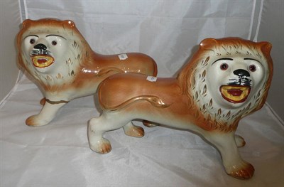Lot 20 - A pair of Staffordshire pottery lions (one with a damaged leg)