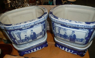 Lot 30 - A pair of modern Chinese blue and white planters on stands