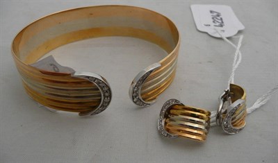 Lot 97 - A three colour gold bangle and a pair of earrings