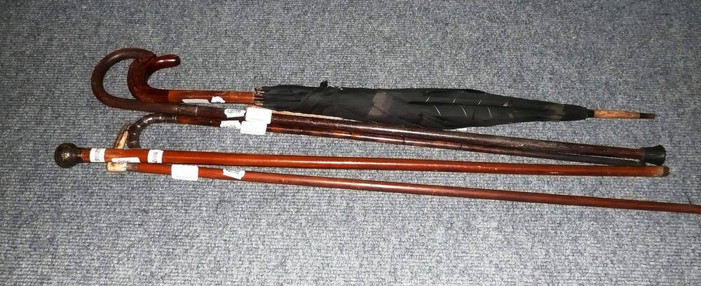 Lot 296 - Four silver mounted walking sticks, canes and an umbrella