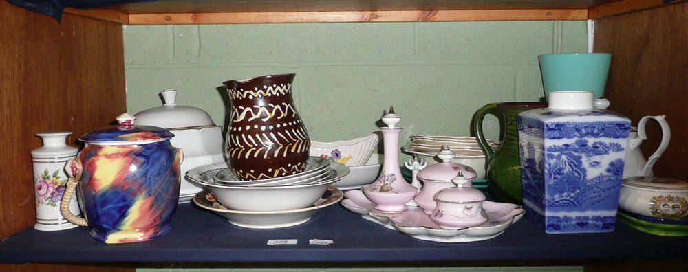 Lot 328 - A shelf including Maling ware biscuit barrel, slipware jug, two Minton green glazed plates, an...