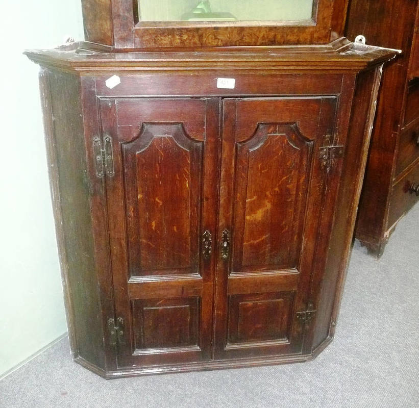 Lot 421 - An 18th century oak double door hanging corner cupboard