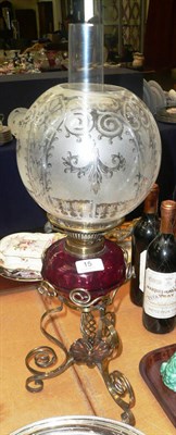 Lot 15 - Brass and copper oil lamp with cranberry reservoir