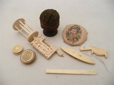Lot 79 - A petit point small panel, a tatting shuttle, a needlework clamp, two pin cushions and a reel etc