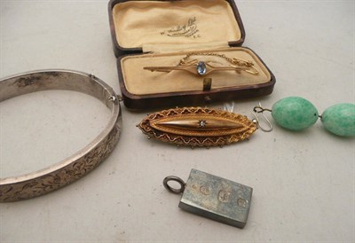 Lot 82 - A 9ct gold Victorian brooch, a bar brooch, a silver bangle, an ingot and a pair of earrings