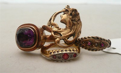 Lot 88 - A ruby and diamond ring stamped '18CT', an Art Nouveau style maiden's head ring and two other rings