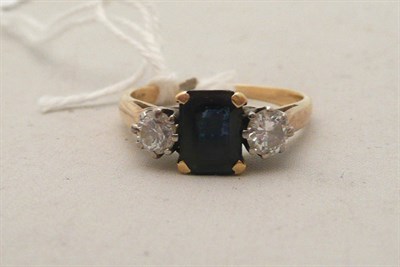 Lot 94 - A ring set with a blue stone and a clear stone to either side
