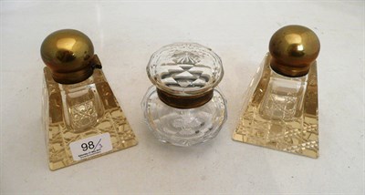 Lot 98 - A pair of glass and brass inkwells and a cut glass jar