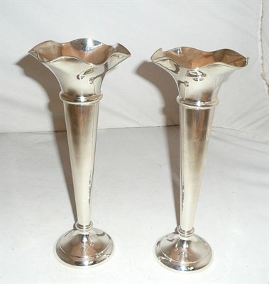 Lot 100 - A pair of loaded silver vases