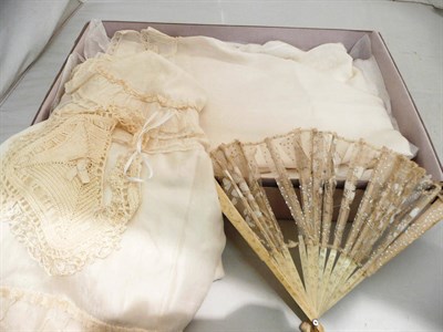 Lot 120 - Late 19th century silk and lace christening gown and cape, two cotton dresses, fan, dolls house...