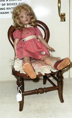 Lot 253 - Miniature dolls chair and a composition doll (2)
